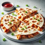 BBQ Chicken Quesadilla sliced into wedges, filled with shredded chicken, BBQ sauce, melted cheese, and topped with green onions.