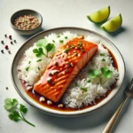 Close-up of Sweet Chili Salmon glazed with sweet chili sauce, served on jasmine rice, garnished with cilantro and lime wedges on a white background.